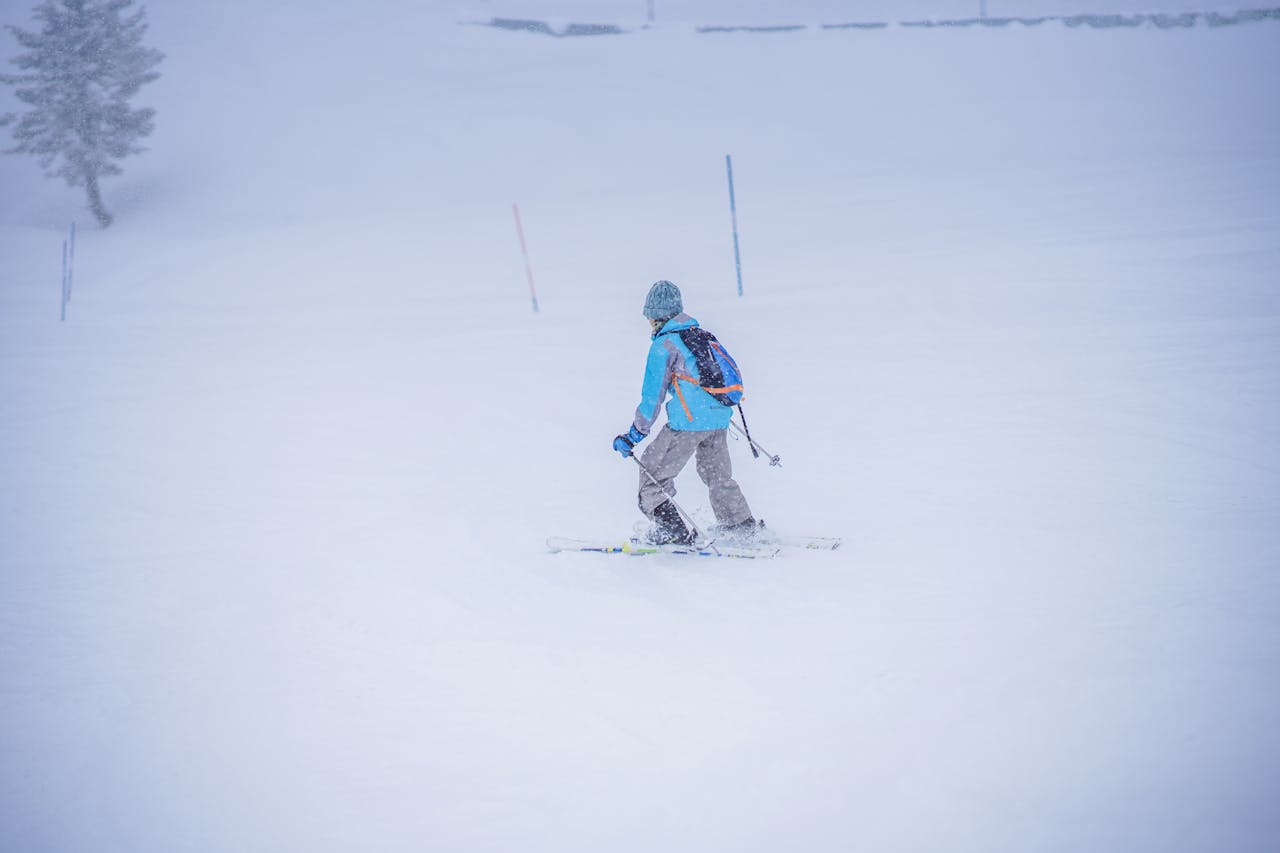 Services A skier enjoying a winter day on the snowy slopes of Gulmarg, creating a thrilling adventure in the snow.
