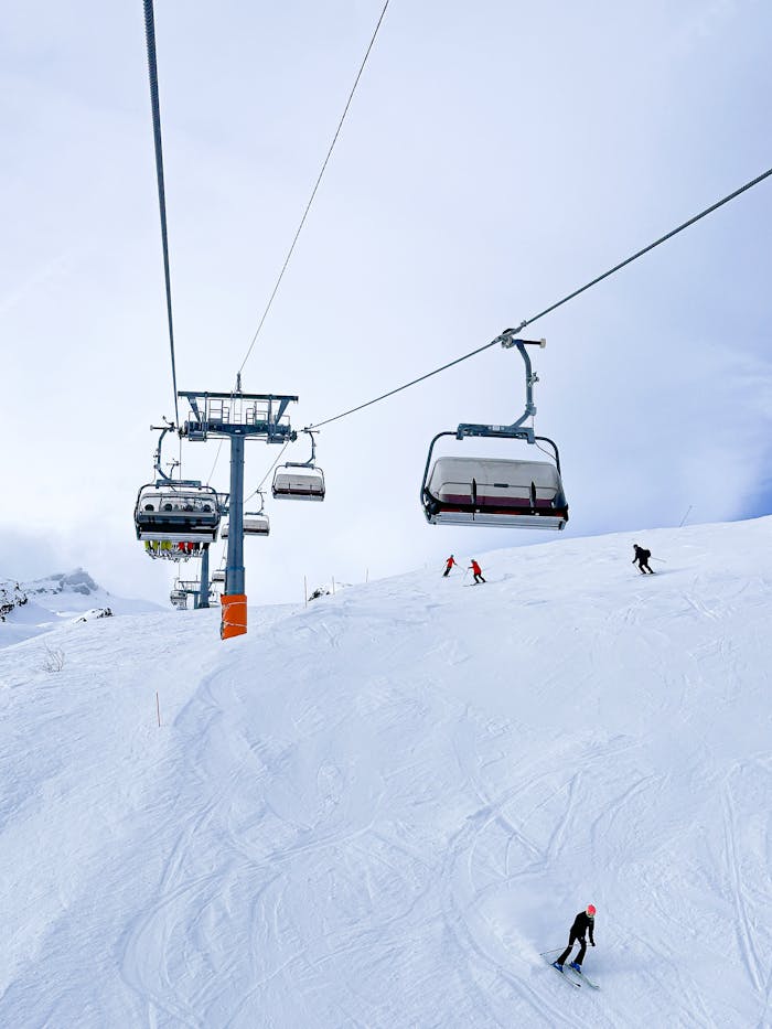 pexels photo 29517030 Skiers gliding down snowy slopes with chairlifts in Lauterbrunnen, Switzerland.